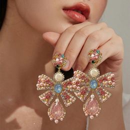 Cuelga la lámpara MENGJIQIAO Coreano de lujo Rosa Bowknot Pendientes colgantes para las mujeres Moda Gota de agua Pendientes de cristal Joyería del partido 231216