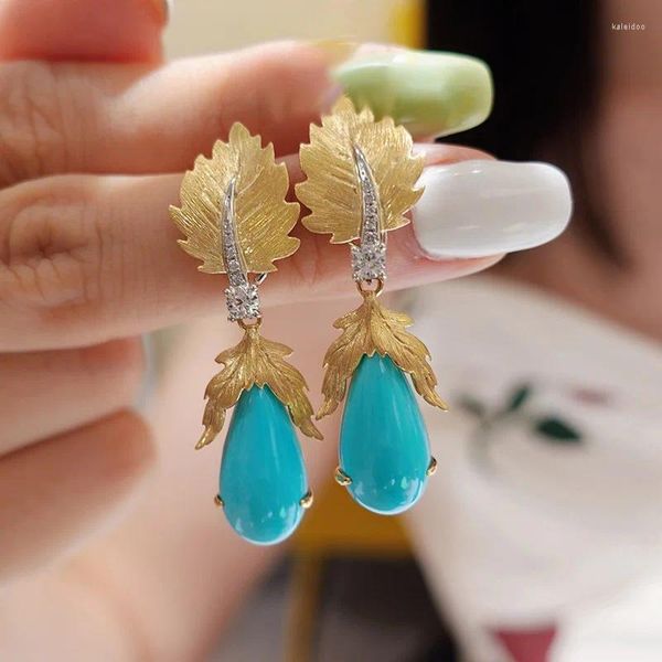 Boucles d'oreilles en pente bohème des feuilles de couleur or vintage des turquoises en pierre bleue bijoux tribaux particuliers