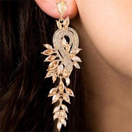 Design boucles d'oreilles enracinement pour les femmes luxe de luxe en métal élégant la chaîne creuse des feuilles de cristal brincos joelry pendent accessoires d'oreille