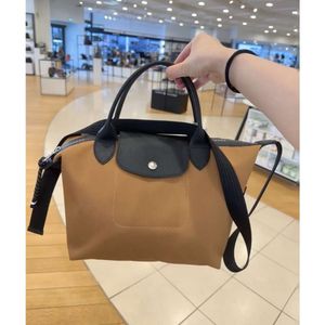 Sac de créateur de haute qualité Nouveau 1512 Small Dumpling Sac Tissu en nylon pour femmes avec toile de vache Casual Crossbody Sac Youth One épaule sac à main