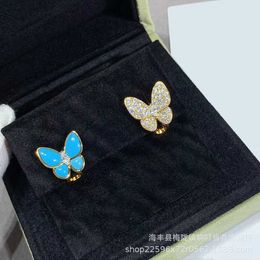 Designer Brand Fashion Gold High Edition Van Butterfly -oorbellen voor vrouwelijke asymmetrische blauwe email Volledige diamant met premium vierbladige gras sieraden