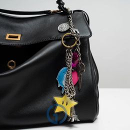 Diseñador Charm Rodeo Bag for Fashion Bag Turner Chain Chain Woemen's Charms de alta calidad