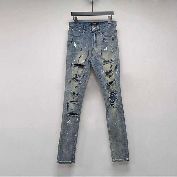 Vêtements de créateurs Pantalons en denim Amiiri Trou d'encre moucheté Jean bleu Coupé au couteau fait à la main Endommagé High Street Élastique Lavage à l'eau Utilisé Slim Fit Distressed Ripped Pants