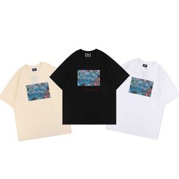 Diseñador de ropa de moda Camisetas Camisetas Niche Fashion Kith Tokyo Bustling Street View Patrón Impreso Casual Versátil Estudiante Camiseta de manga corta para hombres y mujeres