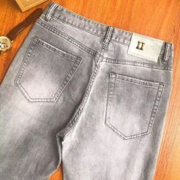 Jeans de créateur Jean monogramme incrusté de diamants pour hommes et femmes avec boutons métalliques agrémentés de jeans monogramme imprimés pour hommes