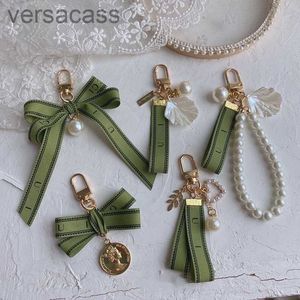 Designer Keychain Luxury Key Chain Sac charme de voiture féminine Ribbon vert perle vert coquille délicate couple Cadeau pendent bien bon 01s5