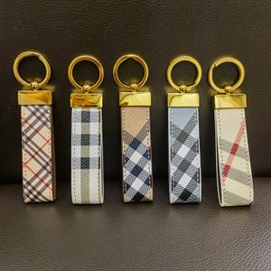 Diseñador Llaveros Llavero de lujo para hombre con hebilla chapada en oro Letras Raya Rejilla Bolsa Encanto Cordón Colgante Coche Cuero Llavero clásico para mujer