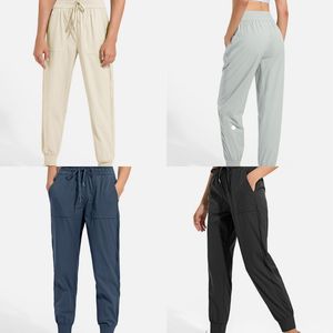 Pantalon de jogging de yoga pour femme avec poches, taille haute, doux, élastique, décontracté, parfait pour le fitness et le yoga, jambes avec cordon de serrage pour un ajustement réglable.