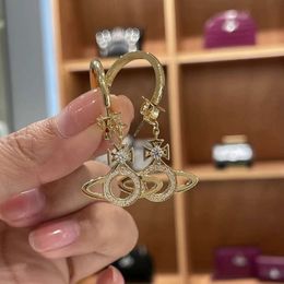 viviane Collier Créateur Viviennes Westwoods Boucles d'oreilles Saturne cerclées de diamants avec boucles d'oreilles détachables - un clou d'oreille de style Ins de luxe personnalisé à deux usages