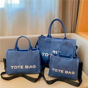 Designer Women's MC Tote Bag Hebei Baigou Bagage Toile Handheld Bag 2024 New Type Couleur solide LETTRE IMPRESSIONNE