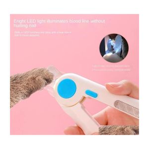 Toilettage pour chiens Fournitures pour animaux de compagnie Nettoyage Lumière LED Position anti-sang Chat Dispositif de perçage des ongles Ciseaux Inventaire Gros Drop Livraison Dhrup