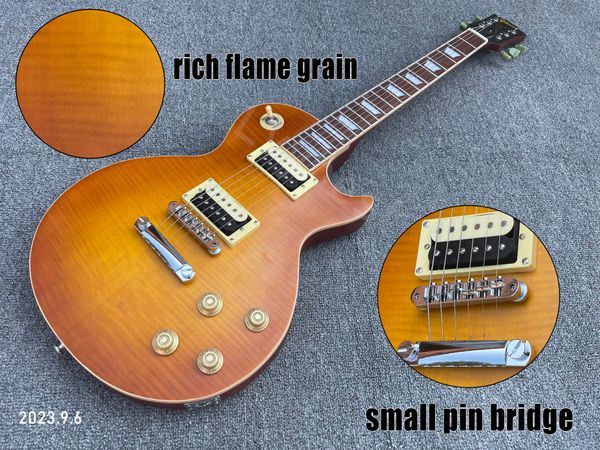 Guitare électrique monobloc corps et manche en acajou riche grain de flamme dessus petit pont à broches couleur crème reliure couleur orange semi-brillant