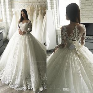 Élégant luxe dentelle appliques manches longues A-ligne robes de mariée pure cou tribunal train illusion bouton dos Dubaï arabe robes de mariée