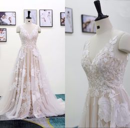 Exquisitos vestidos de novia de una línea Vestidos de novia largos sin espalda sexy Tul de champán con apliques florales de marfil