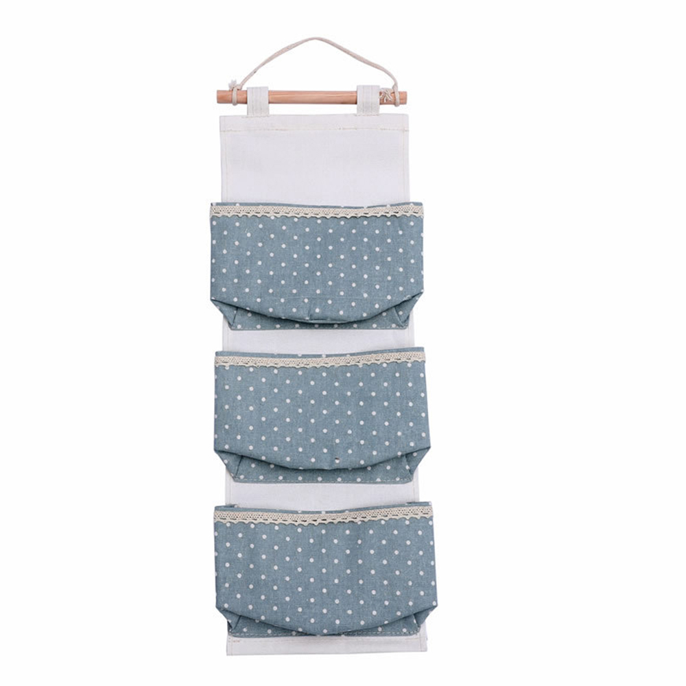 

Blue little three pockets one-piece cotton and linen hanging bag sundries finishing storage bag wall door decorative hanging