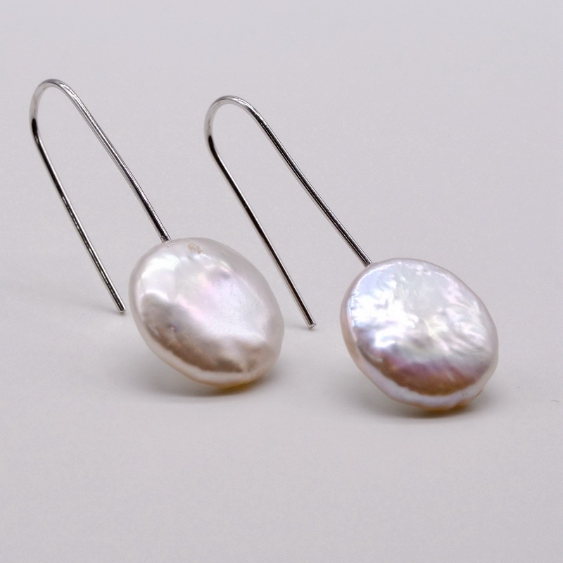 

Pearl earrings. Coin shape baroque pearl. White pearl. Accessories in sterling silver. Women's pearl earrings