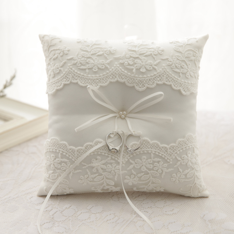 

Wedding ring pillow with embroidery on the bottom of the net
