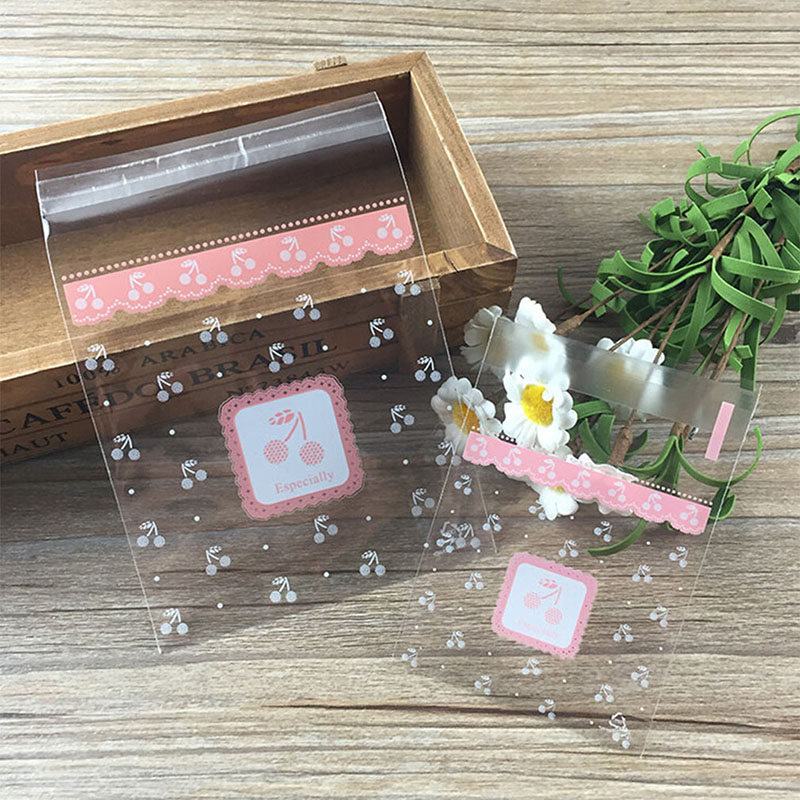 

Popular 100pcs Clear Pink Cherry Candy Cookie Bags Wedding Birthday Party Craft Self Adhesive Plastic Biscuit Packaging Gift Bag