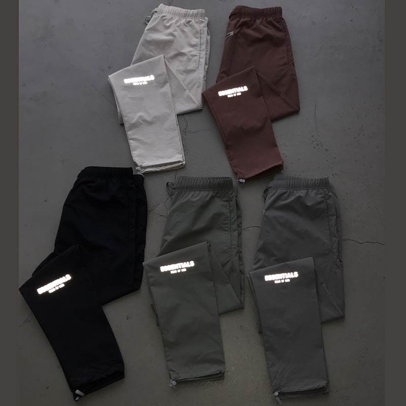 fear of god essentials black reflective track pants