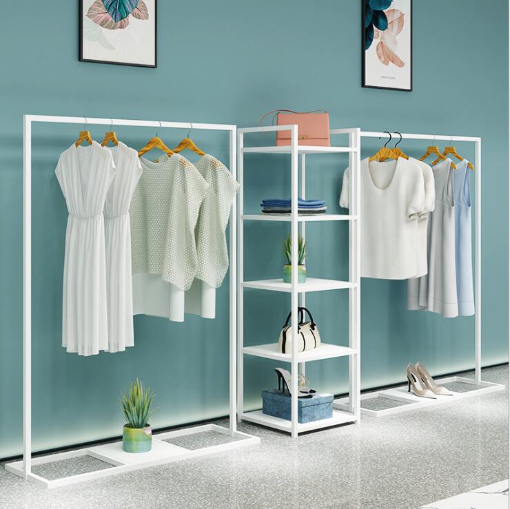 

Simple clothing store display rack floor type men's shop shelf women's clothing store hanging clothes rack white against the wall