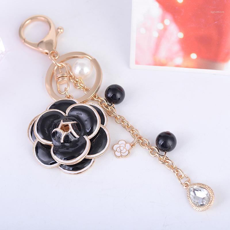 

Creative Fine Crystal Pearl Black White Camellia Keychain Charming Lady Gift Pendant Key Chain Beautiful Bag Accessories Keyring1