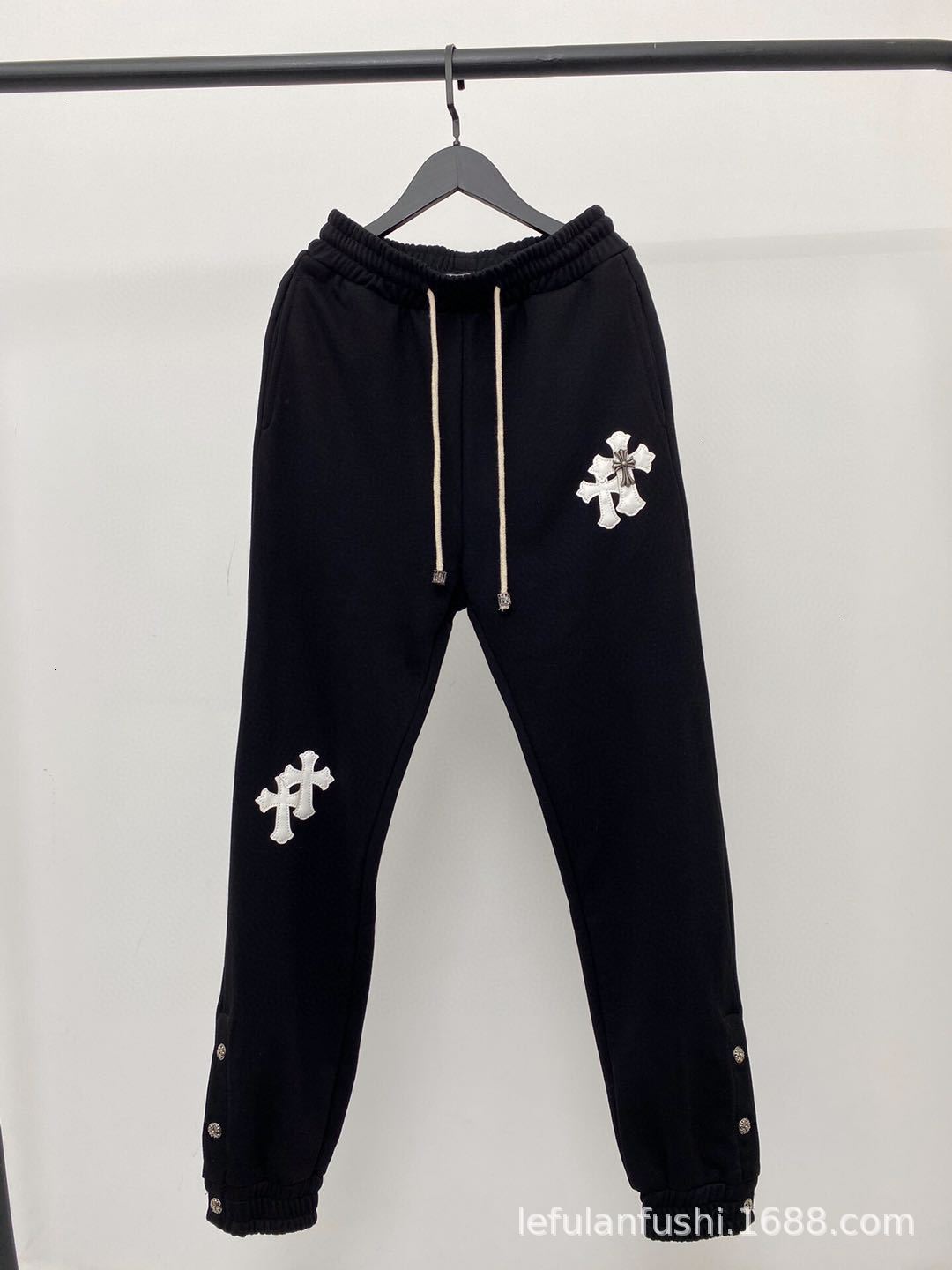 

20ch Crohn black trousers front and back with leather cross embroidery