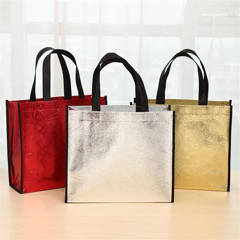 

100pcs/lot High-grade Large Laser Non-woven Bag Hand-held Shopping Bag Clothing Packaging 32x12x27cm/40x12x32cm1