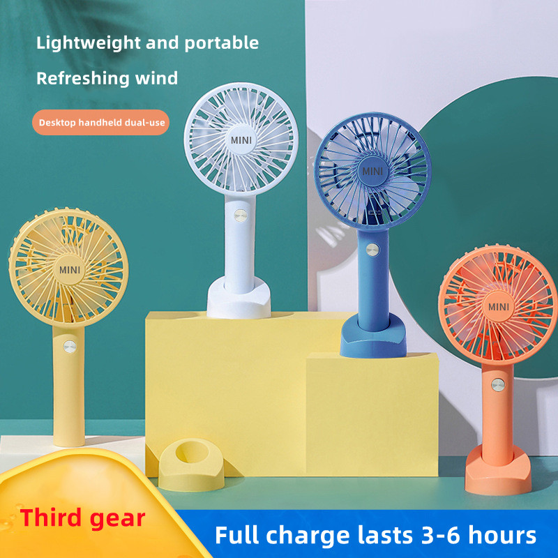 

2022 summer new handheld electric fan portable desktop with mobile phone bracket hand holding USB rechargeable three-speed wind speed mini fan