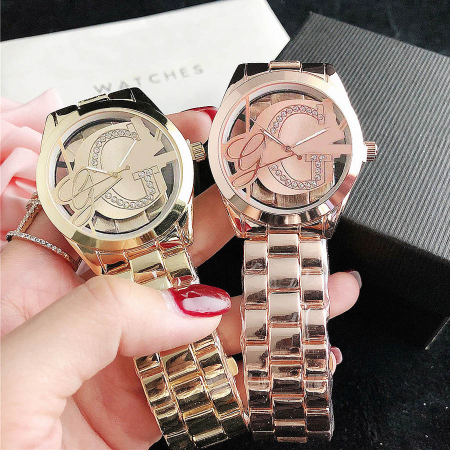 

Brand Watches Women Girl Diamond Crystal Triangle Hollow Out Big Letters Style Metal Steel Band Quartz Wrist Watch GS40, Slivery;brown