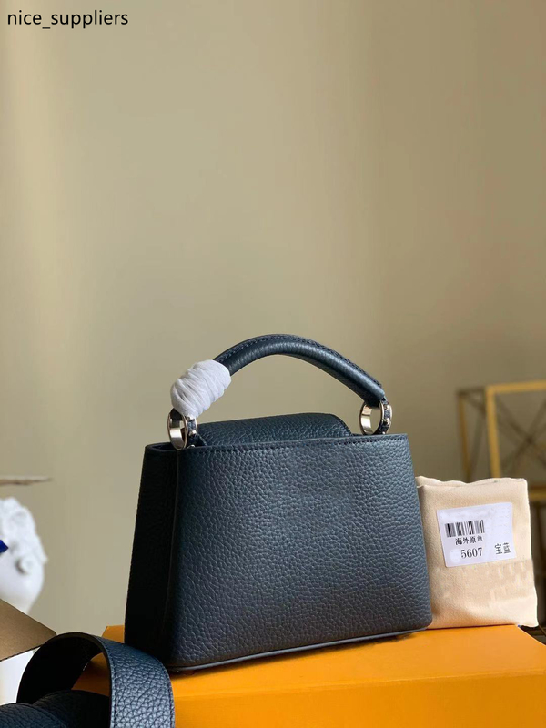 

M56770 CAPUCINES MINI handbag Taurillon leather in Atlantic Dark Blue color classic women totes carried by hand or over the shoulder strap, Black/red