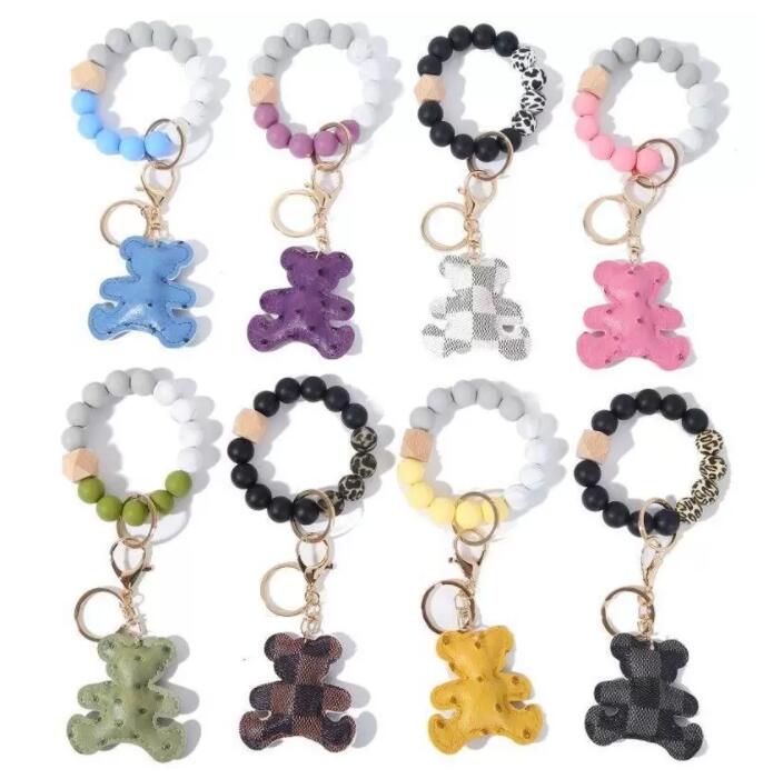 

DHL 8 Styles Silicone Bead Bracelet Keychain Party Wooded Beads Keyring Old Flower Plaid Bear Decoration Key Ring PU Leather Ornament Bag Pendant C0122