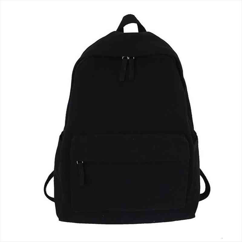 

solid black backpack neutral minimalist style leisure or travel bag 100% cotton canvas school book