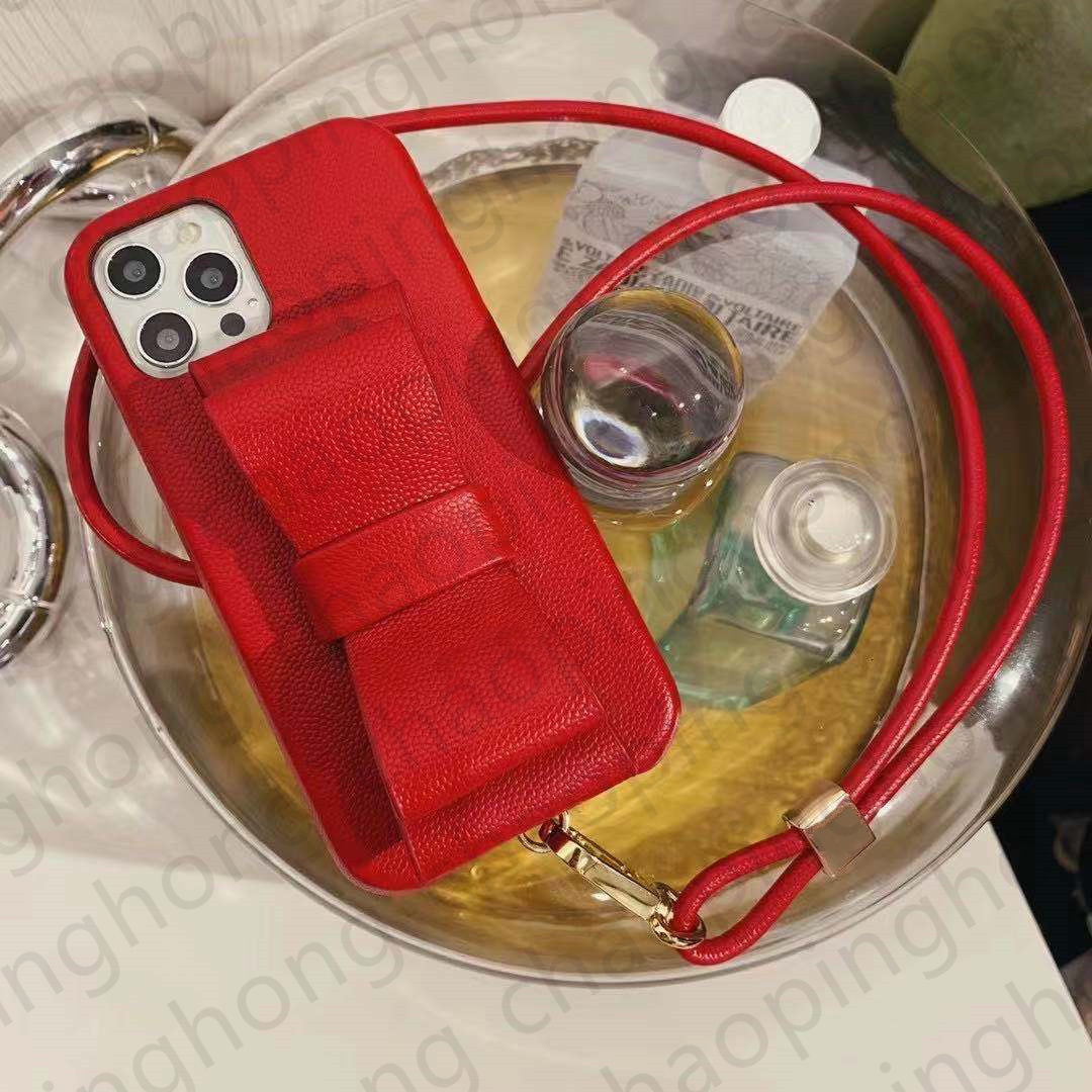 

Luxurys Designers Leather Phone Cases For iphone 13 Pro Max 12 11 XS XR X 8 7 Plus Fashion Satchel Style Bowknot Kickstand Wristband Back Cover Case Luxury Mobile Shell, 3+logo