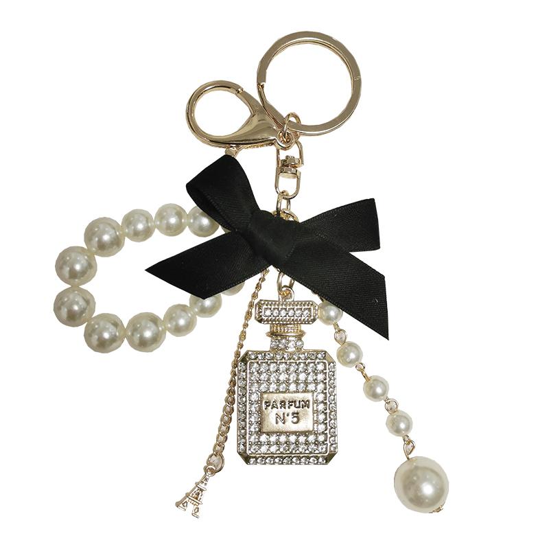 

Keychains Pearl Chain Bottle Keychain For Woman Luxury Jewelry Bow Car Keyring Bowknot Camellia Pendant Bag Decoration