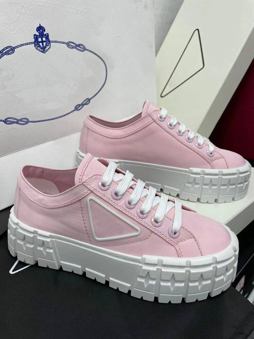 

rubber platform inspired by motocross tires defines unusual shoes design of these nylon gabardine sneakers. The logo triangle decorate50 mm, As picture