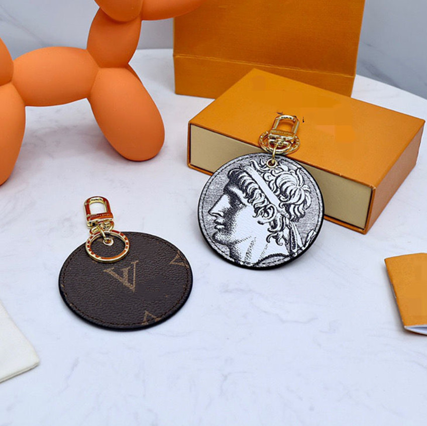 

Designer's New Leather Key Chain CLassic Round Character Pendant With Male and Female Matching Accessories have box