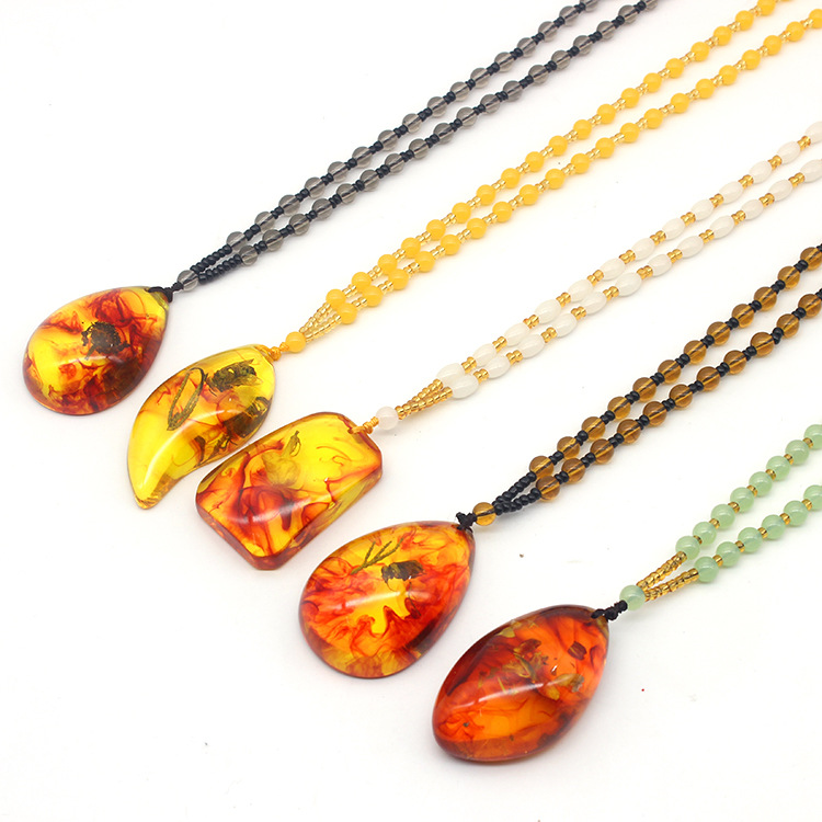 

Wholesale natural plant fossil necklace pendant long imitation beeswax amber sweater chain hot supply will sell gifts hot