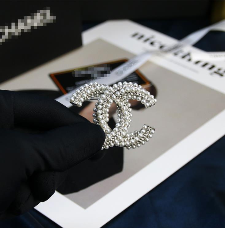 

Three row twisted pearl inlaid diamond lettered Brooch brass