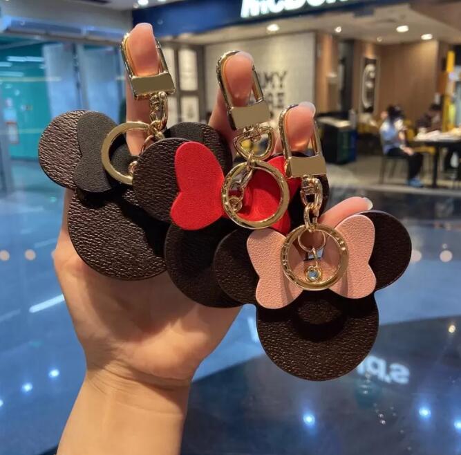 

Wholesale Without Gift Box Luxury Brown Old Flower Four-Leaf Clover PU Leather Mouse Keychains Fashion Bag Decoration Pendant Keyring
