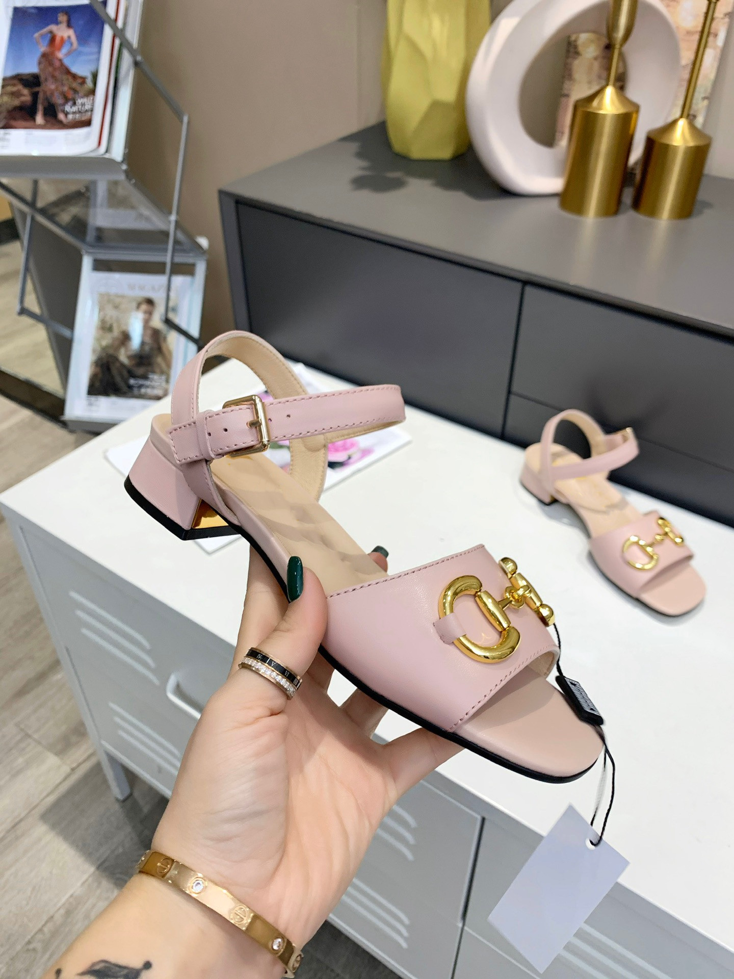 

Leather peep-toe sandals are decorated with the brand's signature horse buckle accessories. Double-ring and elongated designs run throu, Black