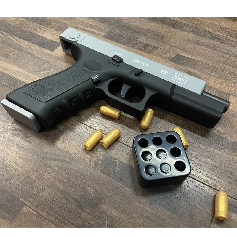 

0165McQuillan bird cannot launch shell throwing Glock manual toy gun under pistol children boy interaction