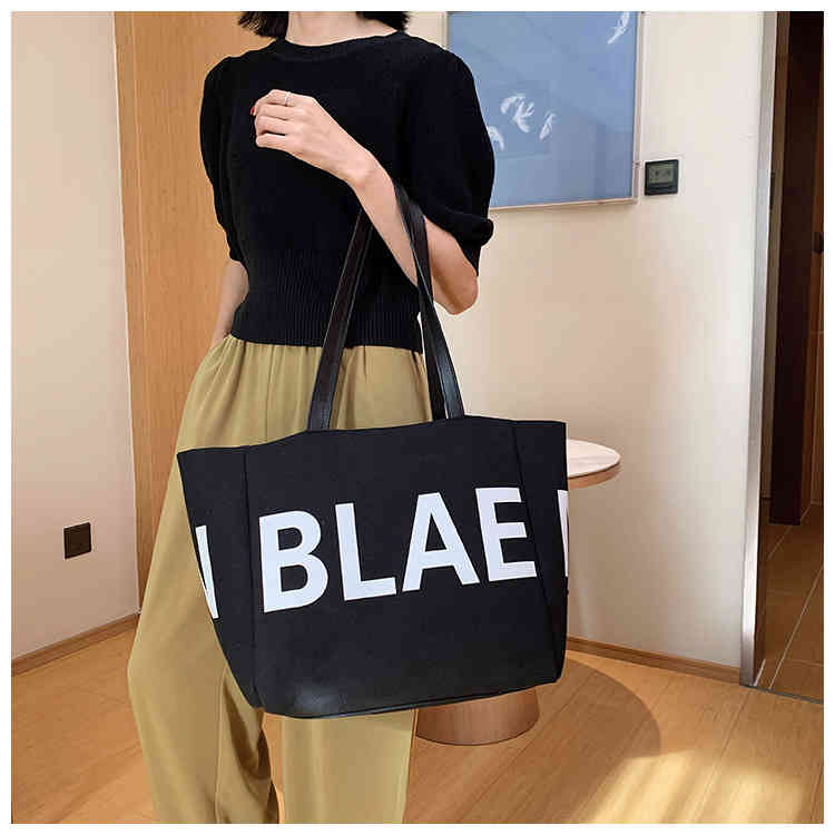 

New creative design advanced sail cloth bag design letter portable commuter leisure bag, White.