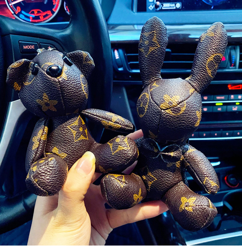 

Party Favor Leather old flower keychain female cute creative bear rabbit doll keychain car key chain bag pendant wholesale