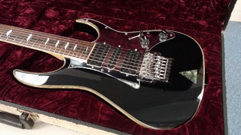 

Custom Shop UV777 Universe Steve Vai 7 Strings Black Electric Guitar Mirror Pickguard, Floyd Rose Tremolo, Abalone Disappearing Pyramid Inlay, HSH Pickups