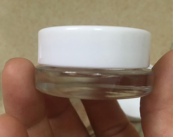 

2018 best selling 5g glass jar stash container mini small bottle 5ml with white lid 42.5mm wax cosmetic cream container custom logo