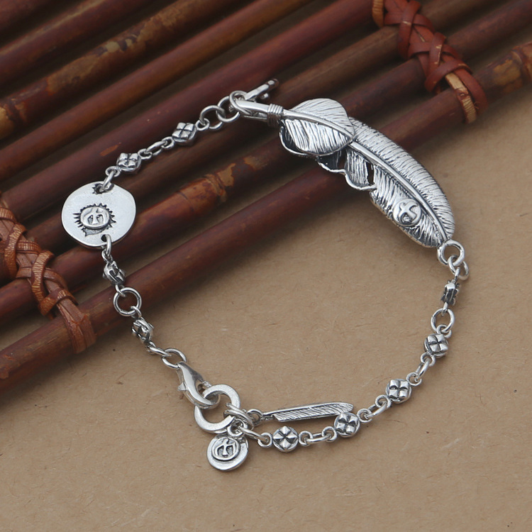 Brand new 925 Sterling silver charm bracelet-stamped charm and huge feather charm with smaller feather style with link chain bracelet