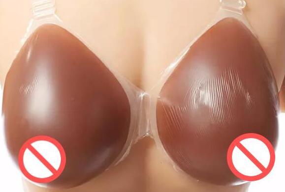 

Free shipping hot selling factory direct supply triangular shape silicone breast forms with transparent straps fake boobs for unisex
