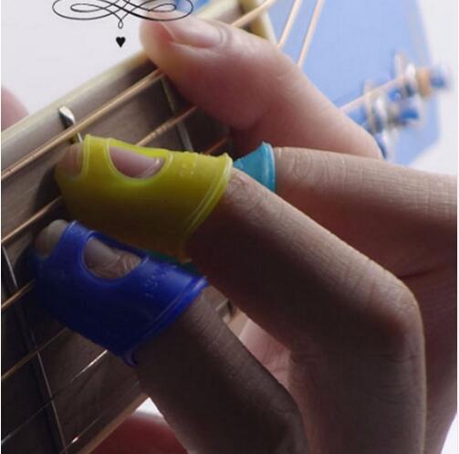 4pcs / Set Guitare Pick FINicone Doigt Doigt de silicone Paddles pour accessoires Ukulélé Couleur aléatoire