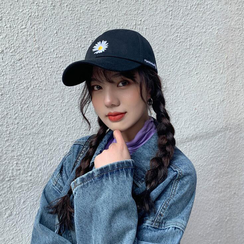 women wearing baseball hats