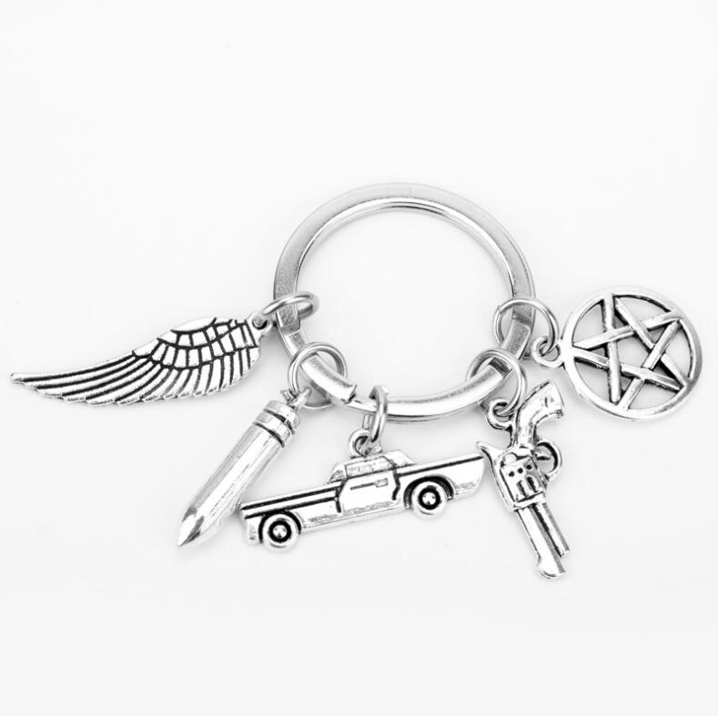 

New Fashion Jewelry Supernatural Keychain Wings Pentagram Pistol Bullet Pendant Keychain Car Pendant Creative pendant key chain Gift 402